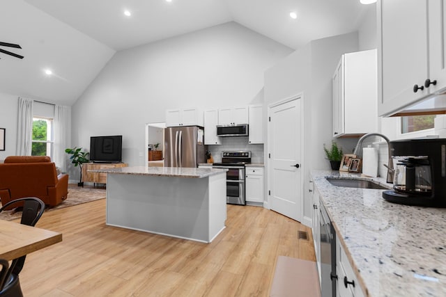 5283 Eagleville Pike, Eagleville, TN 37060 - kitchen with stainless steel appliances, a center island, ceiling fan, open floor plan, and backsplash
