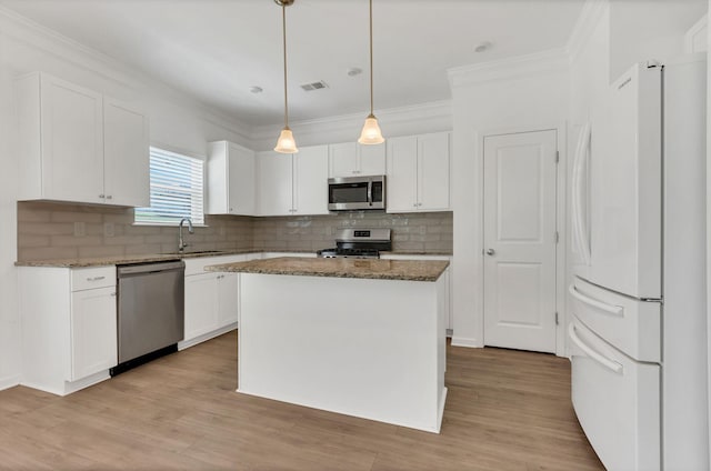 534 Morgan Meadows Way, Columbia, TN 38401 - kitchen with appliances with stainless steel finishes, stone countertops, white cabinets, crown molding, and tasteful backsplash