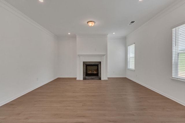 534 Morgan Meadows Way, Columbia, TN 38401 - unfurnished living room featuring healthy amount of natural light, crown molding, a glass covered fireplace, light wood-style flooring, and recessed lighting