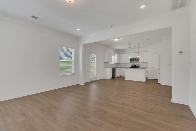 534 Morgan Meadows Way, Columbia, TN 38401 - unfurnished living room featuring crown molding, wood finished floors, and recessed lighting