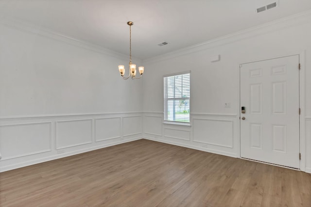 534 Morgan Meadows Way, Columbia, TN 38401 - unfurnished dining area featuring crown molding, a chandelier, wood finished floors, wainscoting, and a decorative wall