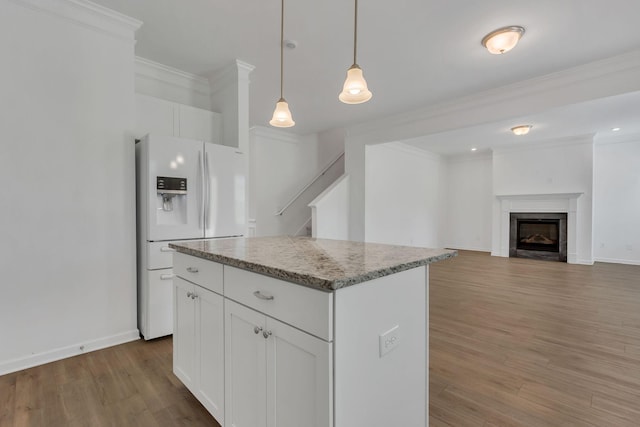 534 Morgan Meadows Way, Columbia, TN 38401 - kitchen featuring white fridge with ice dispenser, light wood-type flooring, a kitchen island, crown molding, and white cabinetry