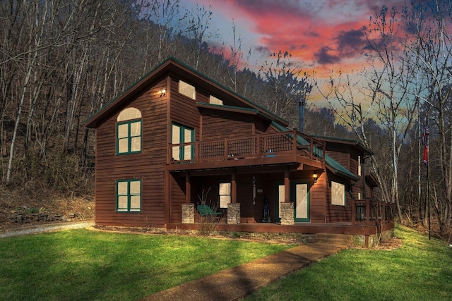 140 Carver Hollow Rd, Pleasant Shade, TN 37145 - rustic home with a front lawn, a wooden deck, and a forest view