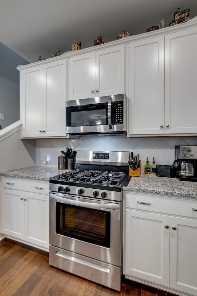 907 Nance Ln, Lebanon, TN 37087 - kitchen featuring stainless steel appliances, white cabinetry, tasteful backsplash, and dark wood finished floors