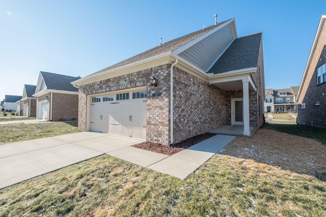 907 Nance Ln, Lebanon, TN 37087 - view of home's exterior with brick siding, driveway, a garage, and roof with shingles
