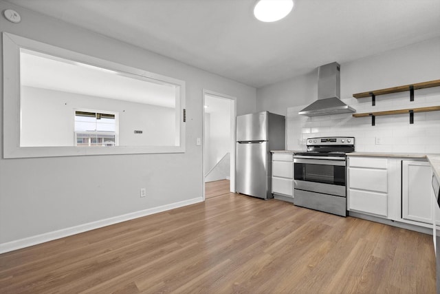 4726 Tarpon Trl, Chattanooga, TN 37416 - kitchen featuring wall chimney range hood, stainless steel appliances, light wood-style floors, light countertops, and white cabinetry