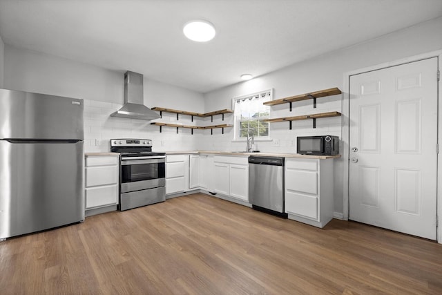 4726 Tarpon Trl, Chattanooga, TN 37416 - kitchen featuring appliances with stainless steel finishes, wall chimney exhaust hood, open shelves, light wood-style flooring, and white cabinetry