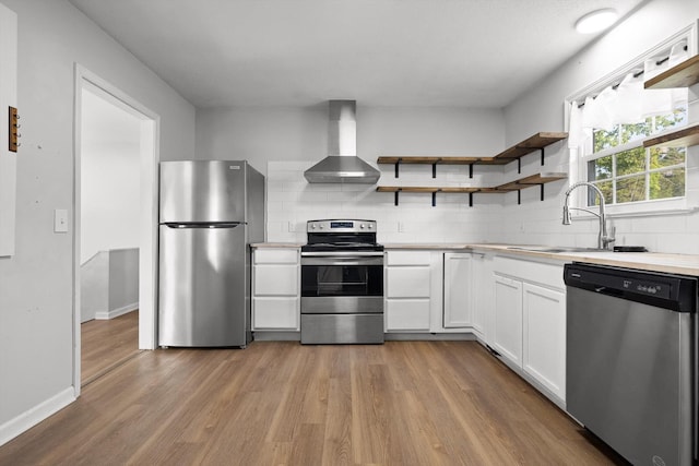 4726 Tarpon Trl, Chattanooga, TN 37416 - kitchen featuring stainless steel appliances, wall chimney range hood, open shelves, white cabinetry, and light countertops