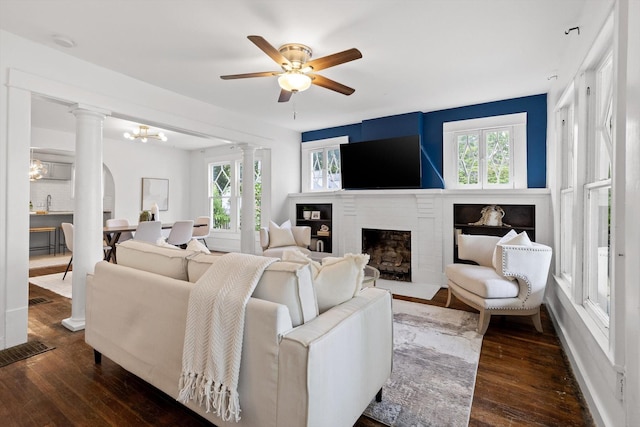 225 Hemphill Ave, Chattanooga, TN 37411 - living room with ornate columns, wood-type flooring, and a brick fireplace