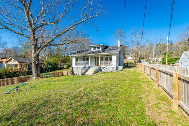 225 Hemphill Ave, Chattanooga, TN 37411 - view of front facade with a porch, a chimney, and a fenced backyard