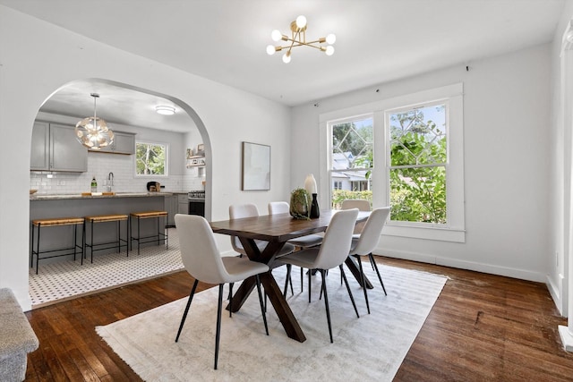 225 Hemphill Ave, Chattanooga, TN 37411 - dining room with a chandelier, arched walkways, and dark wood-style floors