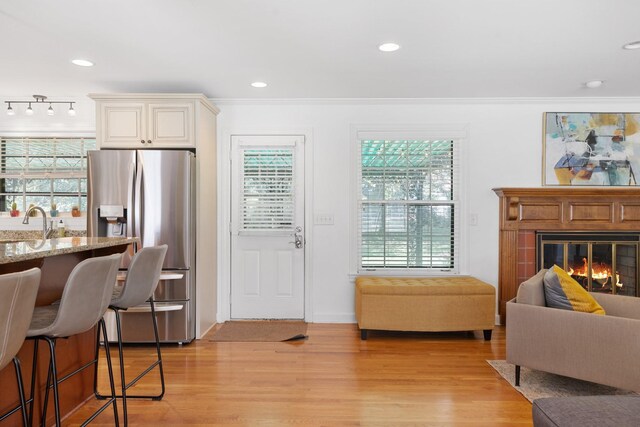 5033 Ragland Dr, Nashville, TN 37220 - living area with light wood-style flooring, healthy amount of natural light, a glass covered fireplace, ornamental molding, and recessed lighting
