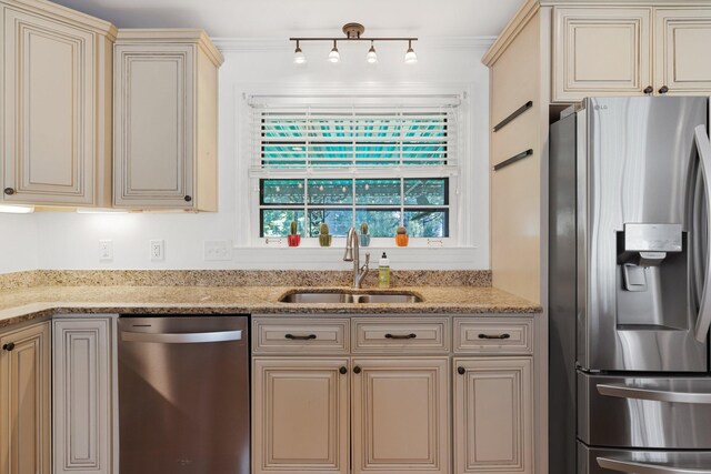 5033 Ragland Dr, Nashville, TN 37220 - kitchen featuring appliances with stainless steel finishes, cream cabinets, light stone countertops, and rail lighting