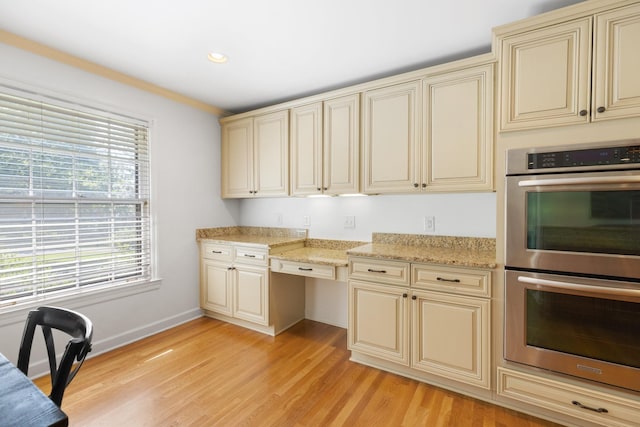 5033 Ragland Dr, Nashville, TN 37220 - kitchen featuring cream cabinetry, stainless steel double oven, light wood-type flooring, recessed lighting, and light stone countertops