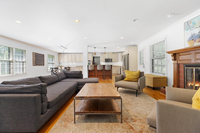 5033 Ragland Dr, Nashville, TN 37220 - living room with light wood-style floors, a glass covered fireplace, recessed lighting, and crown molding