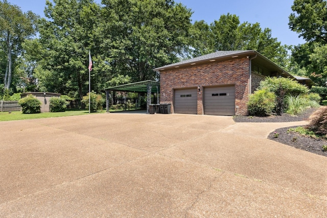 5033 Ragland Dr, Nashville, TN 37220 - view of home's exterior with brick siding, concrete driveway, and a carport