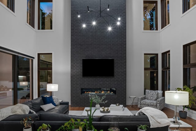 3706 Benham Ave, Nashville, TN 37215 - living room featuring a towering ceiling, wood finished floors, and a tiled fireplace