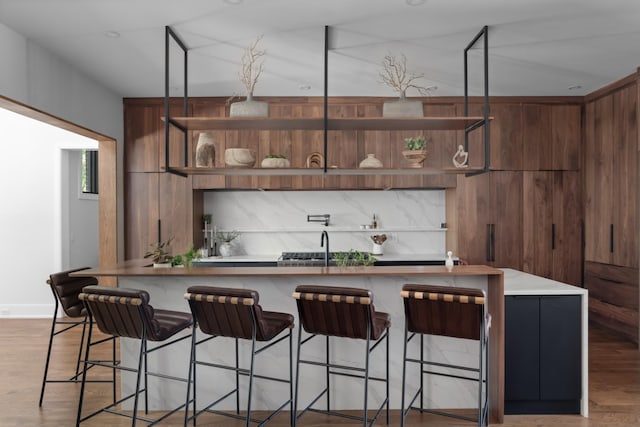 3706 Benham Ave, Nashville, TN 37215 - kitchen featuring open shelves, light wood-style flooring, and a kitchen bar