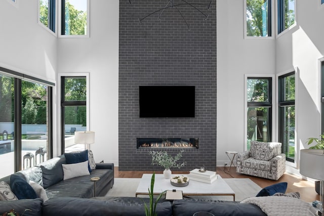 3706 Benham Ave, Nashville, TN 37215 - living area featuring a towering ceiling, plenty of natural light, wood finished floors, and a tile fireplace