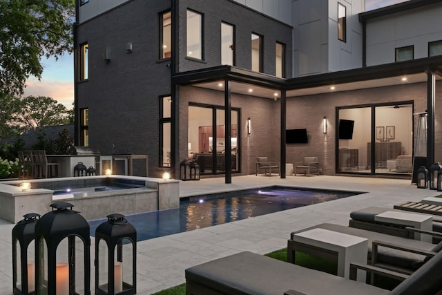 3706 Benham Ave, Nashville, TN 37215 - back of property featuring brick siding, a patio, exterior kitchen, and a pool with connected hot tub