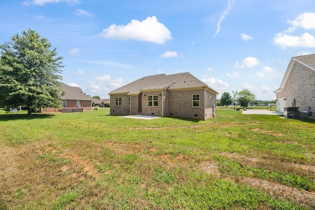 200 Creekside Dr, Lewisburg, TN 37091 - rear view of house featuring crawl space, a patio area, brick siding, and a lawn