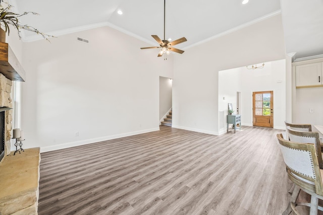 200 Creekside Dr, Lewisburg, TN 37091 - unfurnished living room featuring high vaulted ceiling, stairway, crown molding, light wood-style floors, and a fireplace