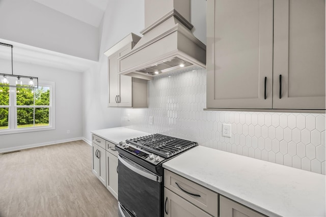 198 Creekside Dr, Lewisburg, TN 37091 - kitchen featuring stainless steel gas range, custom exhaust hood, light wood-style floors, tasteful backsplash, and gray cabinetry