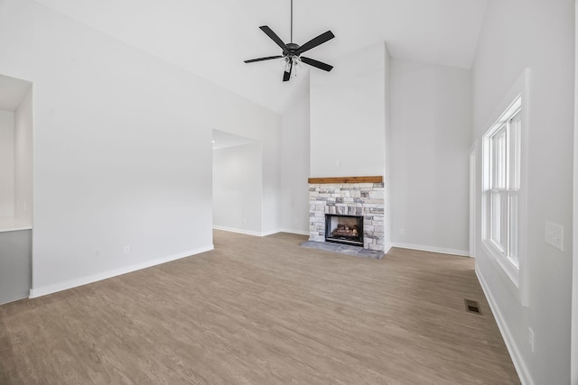 198 Creekside Dr, Lewisburg, TN 37091 - unfurnished living room with high vaulted ceiling, wood finished floors, a ceiling fan, and a stone fireplace