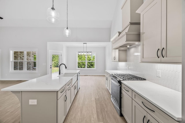 198 Creekside Dr, Lewisburg, TN 37091 - kitchen with gas stove, light wood-style floors, decorative backsplash, premium range hood, and an island with sink