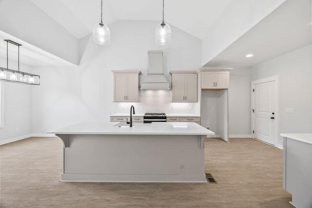 198 Creekside Dr, Lewisburg, TN 37091 - kitchen featuring custom exhaust hood, high vaulted ceiling, light countertops, range, and decorative light fixtures