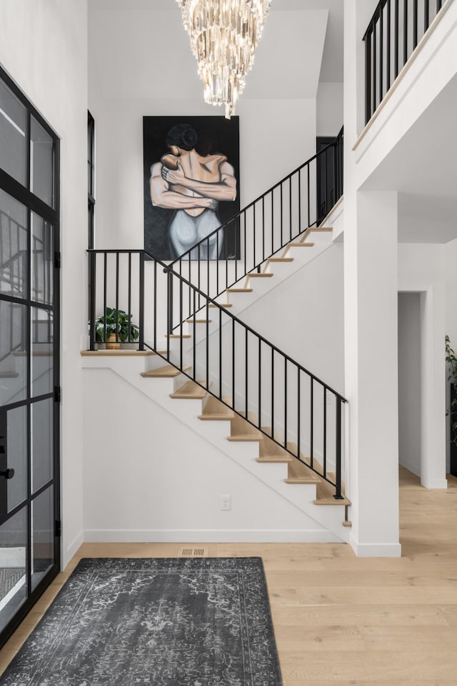 3037 Lakeshore Dr, Old Hickory, TN 37138 - stairway featuring wood finished floors, a chandelier, and a towering ceiling