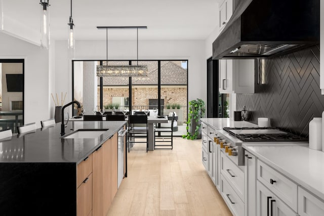 3037 Lakeshore Dr, Old Hickory, TN 37138 - kitchen featuring extractor fan, appliances with stainless steel finishes, a chandelier, light wood-type flooring, and tasteful backsplash