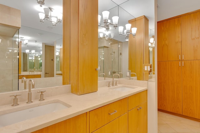 417 Frazier Ave Unit 404, Chattanooga, TN 37405 - bathroom with a chandelier, double vanity, a stall shower, and tile patterned flooring
