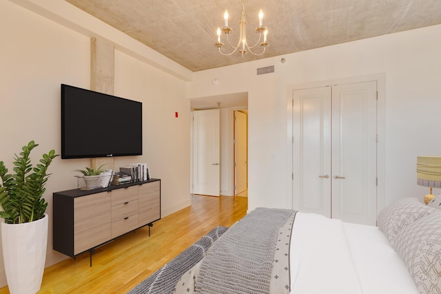 417 Frazier Ave Unit 404, Chattanooga, TN 37405 - bedroom featuring light wood-type flooring, a chandelier, and a closet