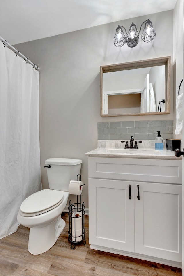 200 Woodsong Ln, Columbia, TN 38401 - full bathroom featuring vanity, backsplash, wood finished floors, and a shower with shower curtain
