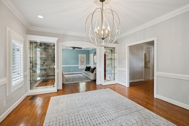 103 Wellesley Pl, Columbia, TN 38401 - unfurnished dining area featuring wood finished floors, crown molding, a ceiling fan, and a chandelier