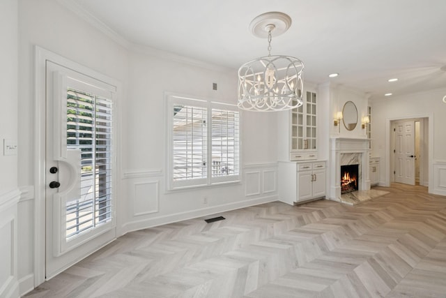 103 Wellesley Pl, Columbia, TN 38401 - unfurnished dining area featuring a chandelier, a decorative wall, recessed lighting, a high end fireplace, and ornamental molding