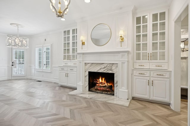 103 Wellesley Pl, Columbia, TN 38401 - unfurnished living room featuring a chandelier, crown molding, a premium fireplace, recessed lighting, and a decorative wall