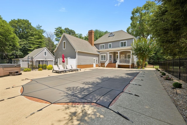 103 Wellesley Pl, Columbia, TN 38401 - back of house with a hot tub, a chimney, a patio, and covered porch