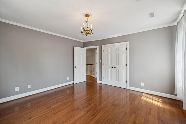 103 Wellesley Pl, Columbia, TN 38401 - unfurnished bedroom with a chandelier, wood finished floors, ornamental molding, and a closet