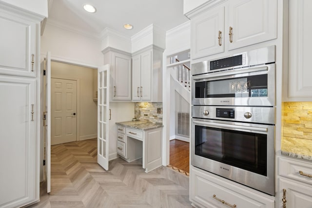 103 Wellesley Pl, Columbia, TN 38401 - kitchen with stainless steel double oven, white cabinets, recessed lighting, light stone countertops, and ornamental molding