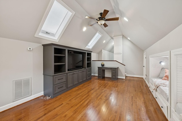 103 Wellesley Pl, Columbia, TN 38401 - unfurnished living room with a skylight, ceiling fan, vaulted ceiling, light wood-type flooring, and a desk