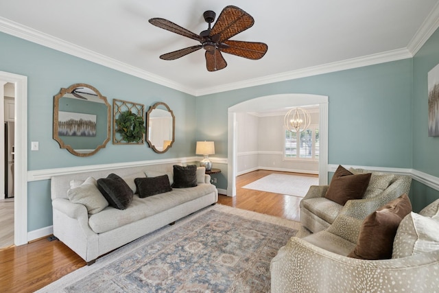 103 Wellesley Pl, Columbia, TN 38401 - living area with ornamental molding, arched walkways, wood finished floors, a chandelier, and ceiling fan