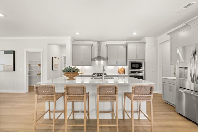 2453 Williams Ridge Dr, Columbia, TN 38401 - kitchen with stainless steel appliances, wall chimney range hood, gray cabinetry, tasteful backsplash, and ornamental molding
