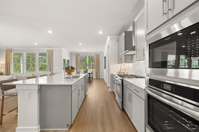 2453 Williams Ridge Dr, Columbia, TN 38401 - kitchen featuring stainless steel appliances, light countertops, a center island with sink, decorative backsplash, and recessed lighting
