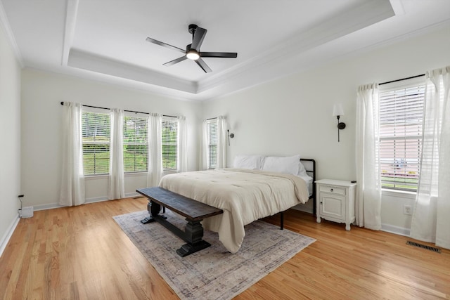 9401 Lazy Circles Dr, Ooltewah, TN 37363 - bedroom with a raised ceiling, ornamental molding, light wood-style flooring, and a ceiling fan