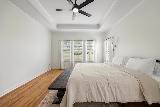 9401 Lazy Circles Dr, Ooltewah, TN 37363 - bedroom featuring a raised ceiling, light wood-style flooring, crown molding, and ceiling fan