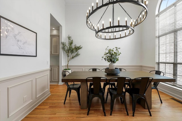 9401 Lazy Circles Dr, Ooltewah, TN 37363 - dining space with plenty of natural light, wainscoting, light wood finished floors, a chandelier, and a decorative wall