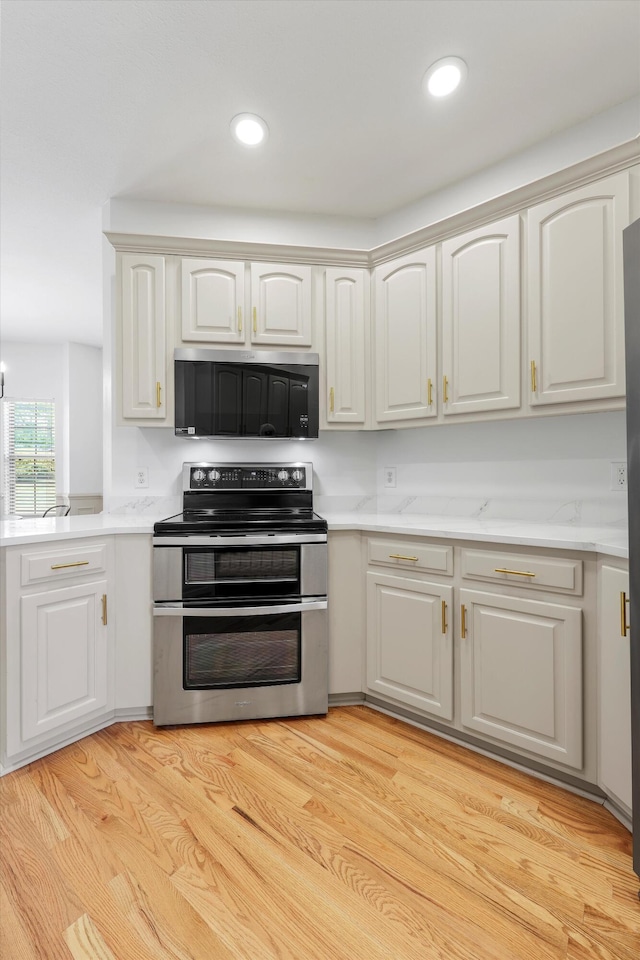 9401 Lazy Circles Dr, Ooltewah, TN 37363 - kitchen with stainless steel appliances, light countertops, recessed lighting, and light wood-style floors