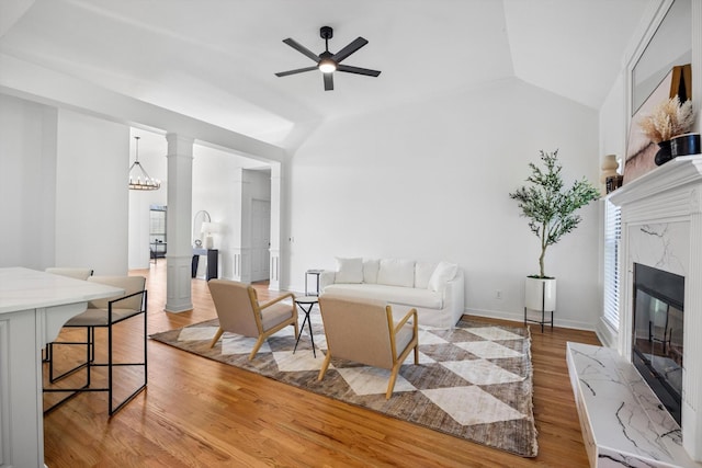 9401 Lazy Circles Dr, Ooltewah, TN 37363 - living area featuring vaulted ceiling, a high end fireplace, light wood-style floors, and ceiling fan